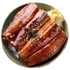 A bowl of glazed, Grilled Eel garnished with sesame seeds and served with a side of pickled ginger, displayed against a White background.